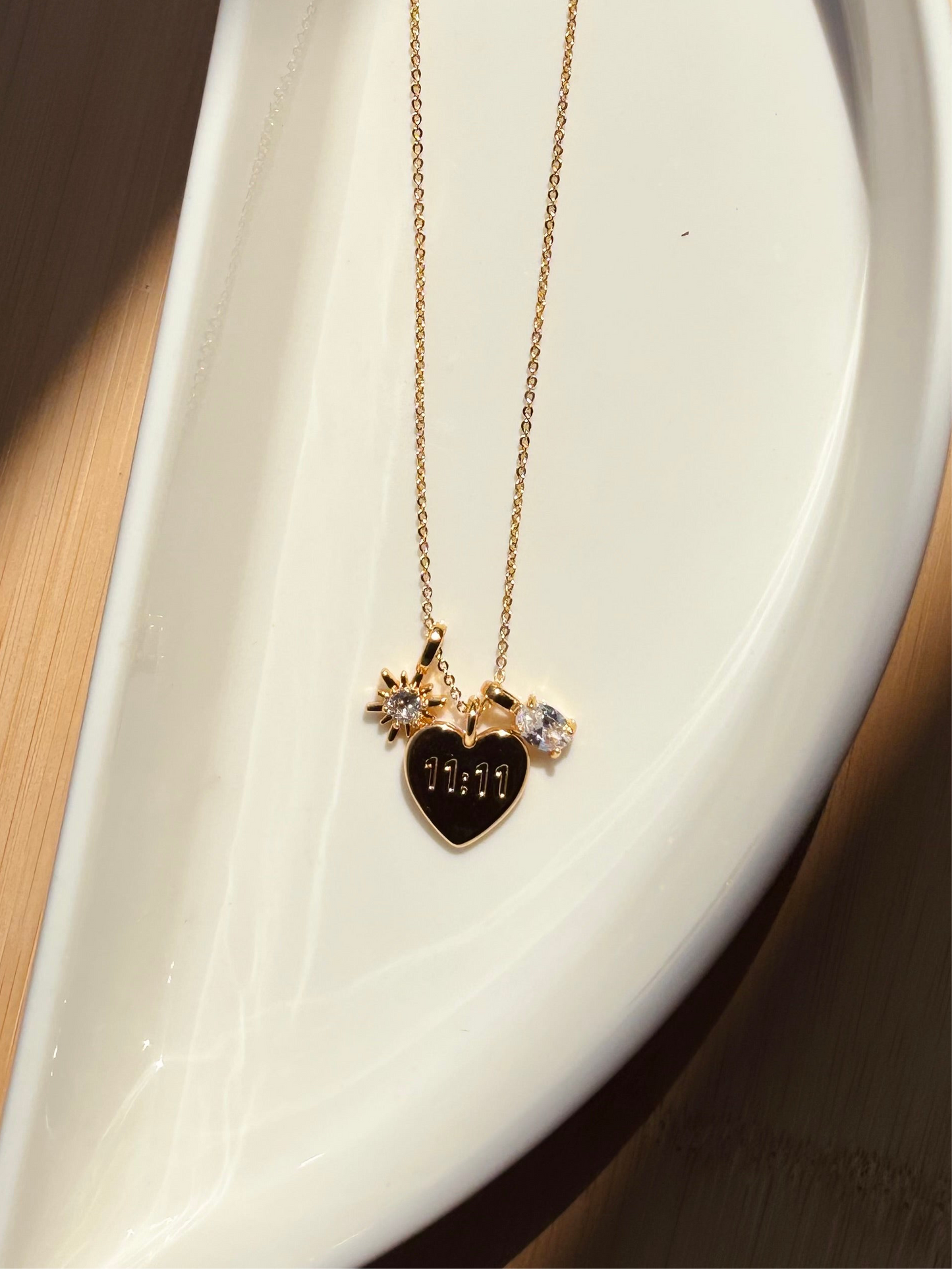 11:11 gold-plated charm necklace styled flat — meaningful manifestation pendant for layering and gifting.