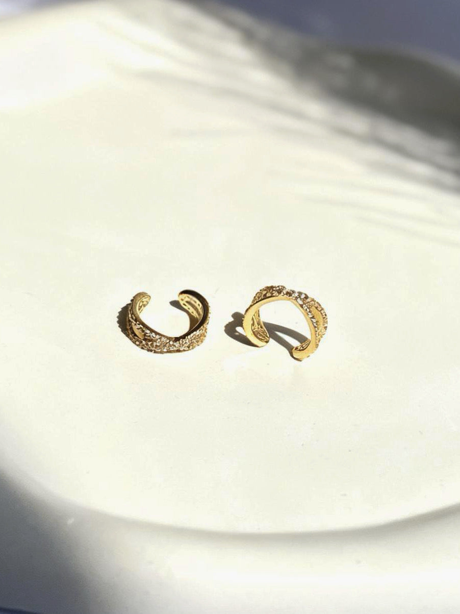 Close-up of gold-plated interlock ear cuff — sleek lightweight cuff for everyday and festive ear stacks.