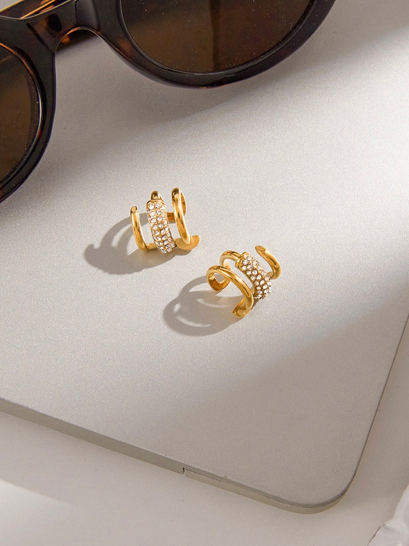 Styled view of 18k gold-plated ear cuff — sleek no-piercing single-piece cuff for festive ear stacks.