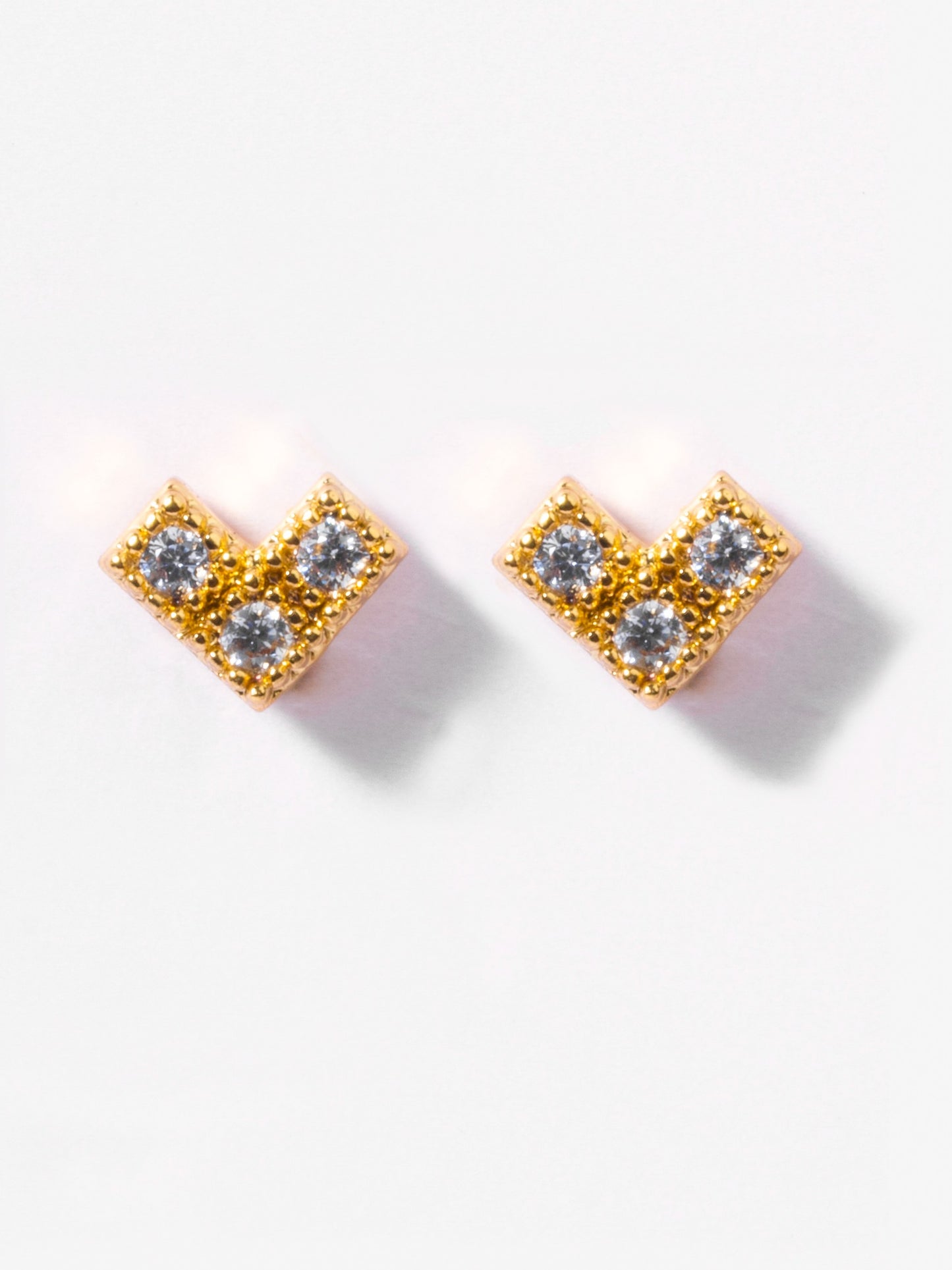 Close-up of Rory ball-back stud earrings — 18k gold-plated sleek modern studs for casual wear.