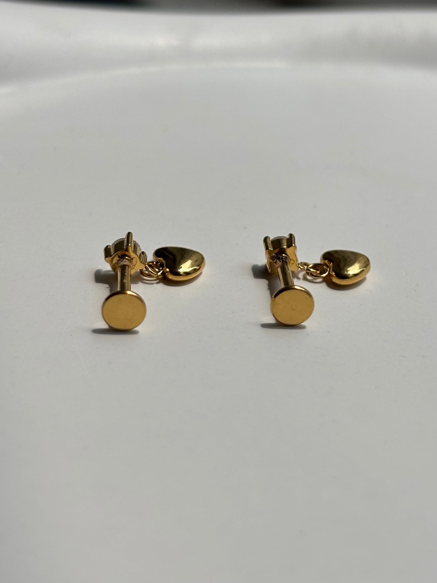 Close-up of heart drop flat-back stud earrings — 18k gold-plated sleep-friendly heart drop studs for casual wear.