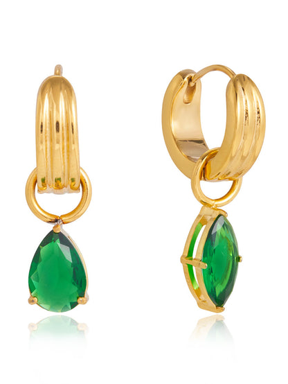 Gold hoop earrings with green gemstones on a white background