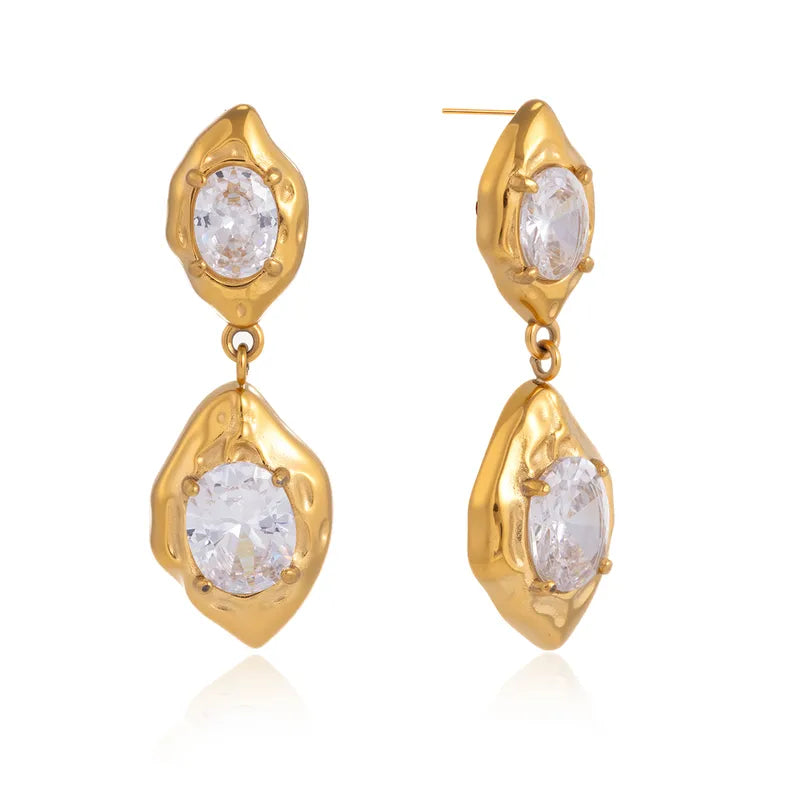Pair of gold stone drop earrings styled for evening wear — statement 18k gold-plated drops.