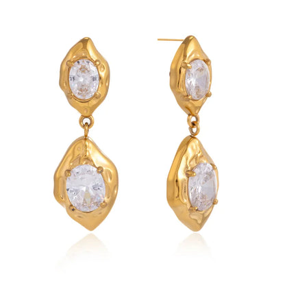 Pair of gold stone drop earrings styled for evening wear — statement 18k gold-plated drops.
