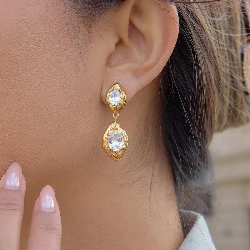 Close-up of gold stone drop earrings — eye-catching stone-set drops in 18k gold-plated stainless steel.