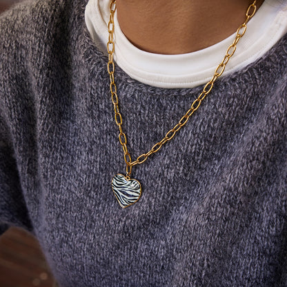 Styled view of zebra heart necklace — 18k gold-plated bold pendant for statement evening wear.