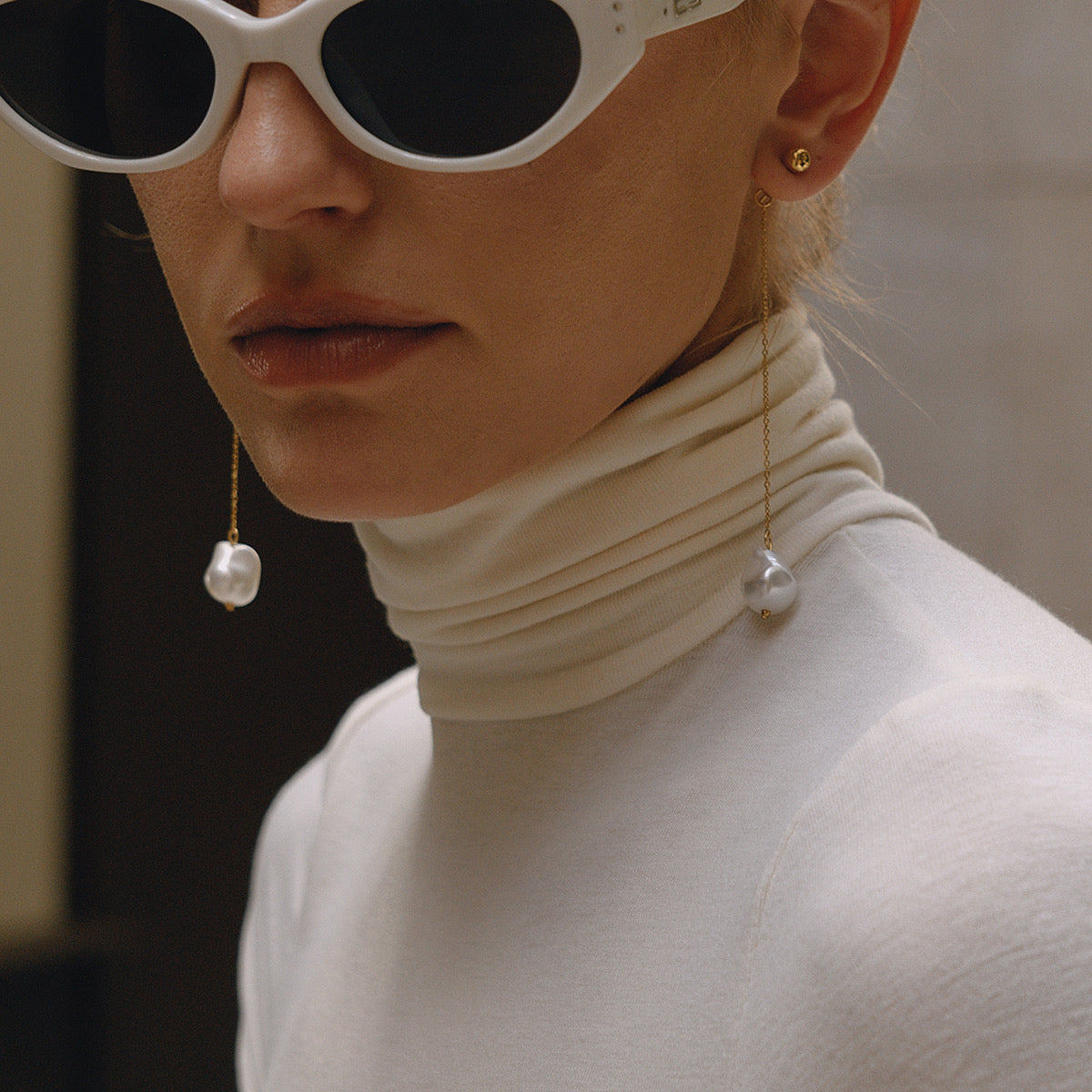 Close-up of pearl drop earrings — 18k gold-plated lightweight elegant pearl drops for everyday and evening.