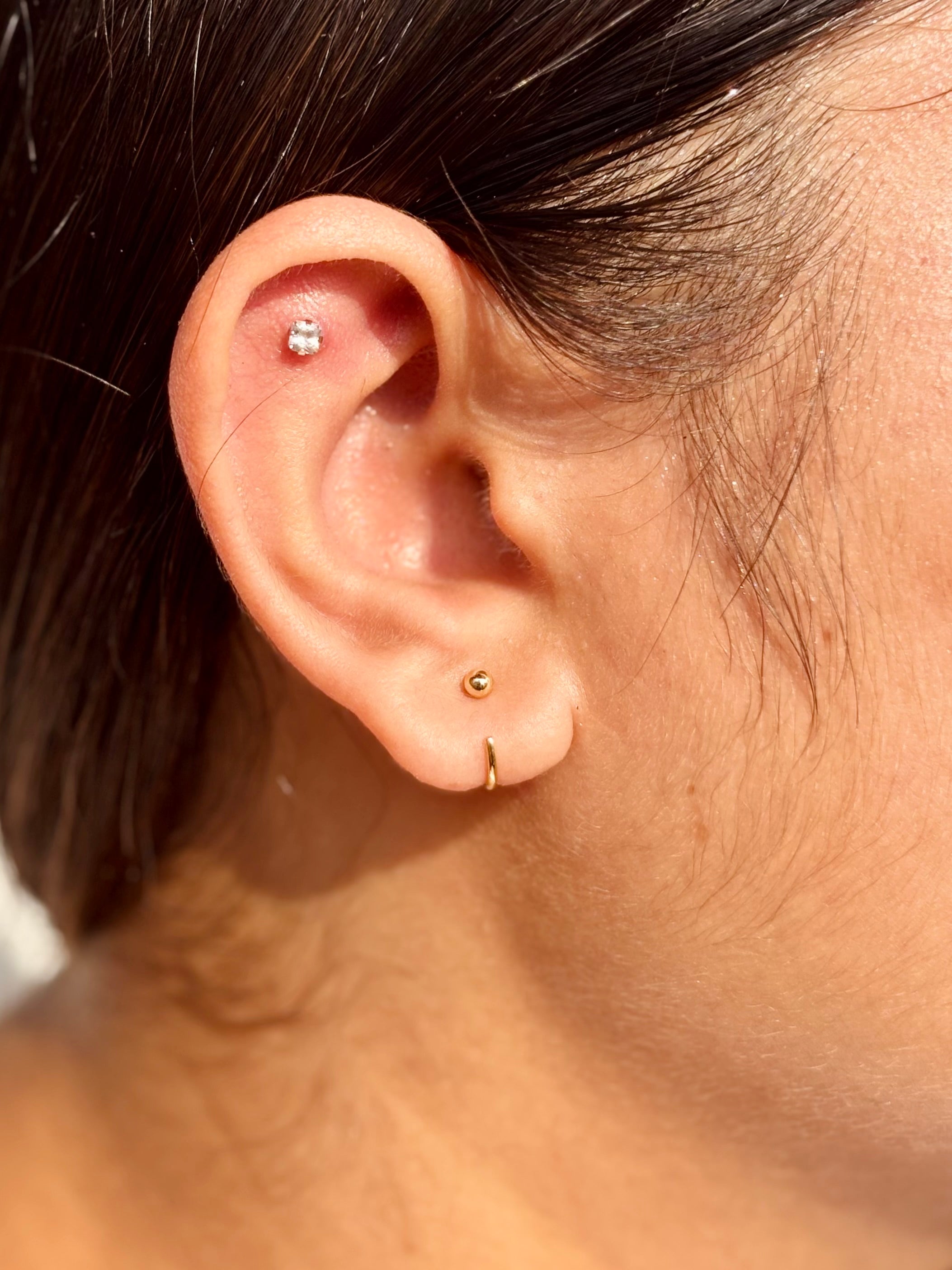 Woman wearing 925 sterling silver poke-free ball hoop earrings — minimalist hoops styled for office and everyday wear.