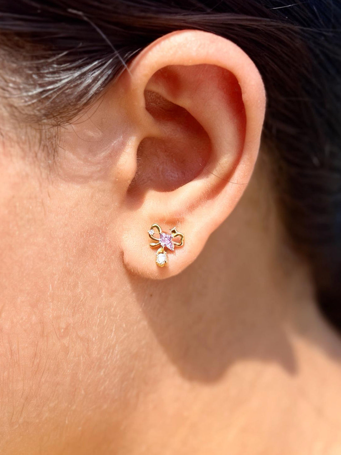Detail shot of bow ball-back earrings — gold-plated sweet bow studs for casual styling and gifting.