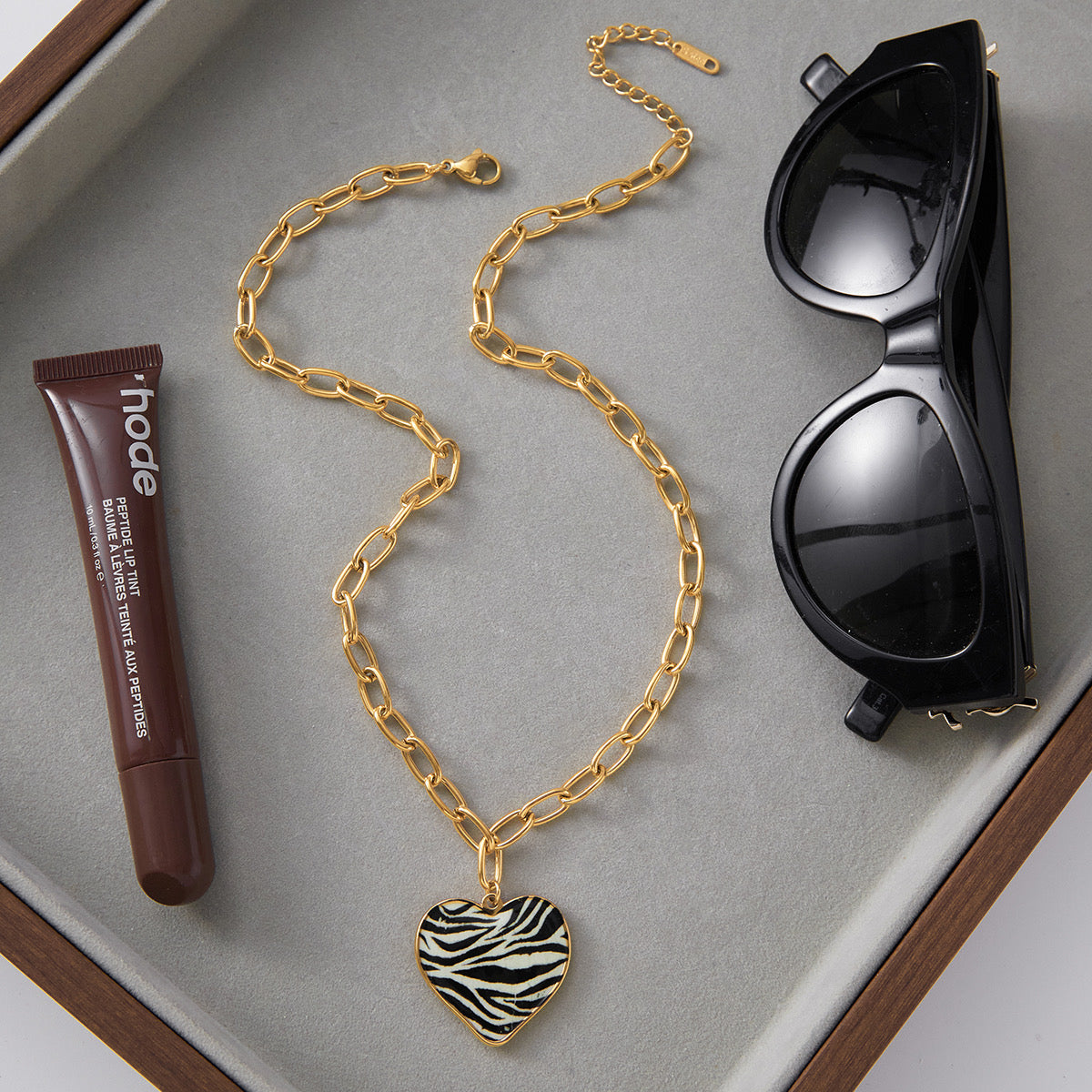 Close-up of zebra heart pendant — 18k gold-plated heart-shape pendant for evening and gifting.