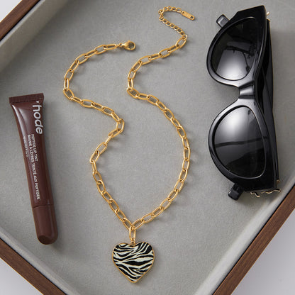 Close-up of zebra heart pendant — 18k gold-plated heart-shape pendant for evening and gifting.