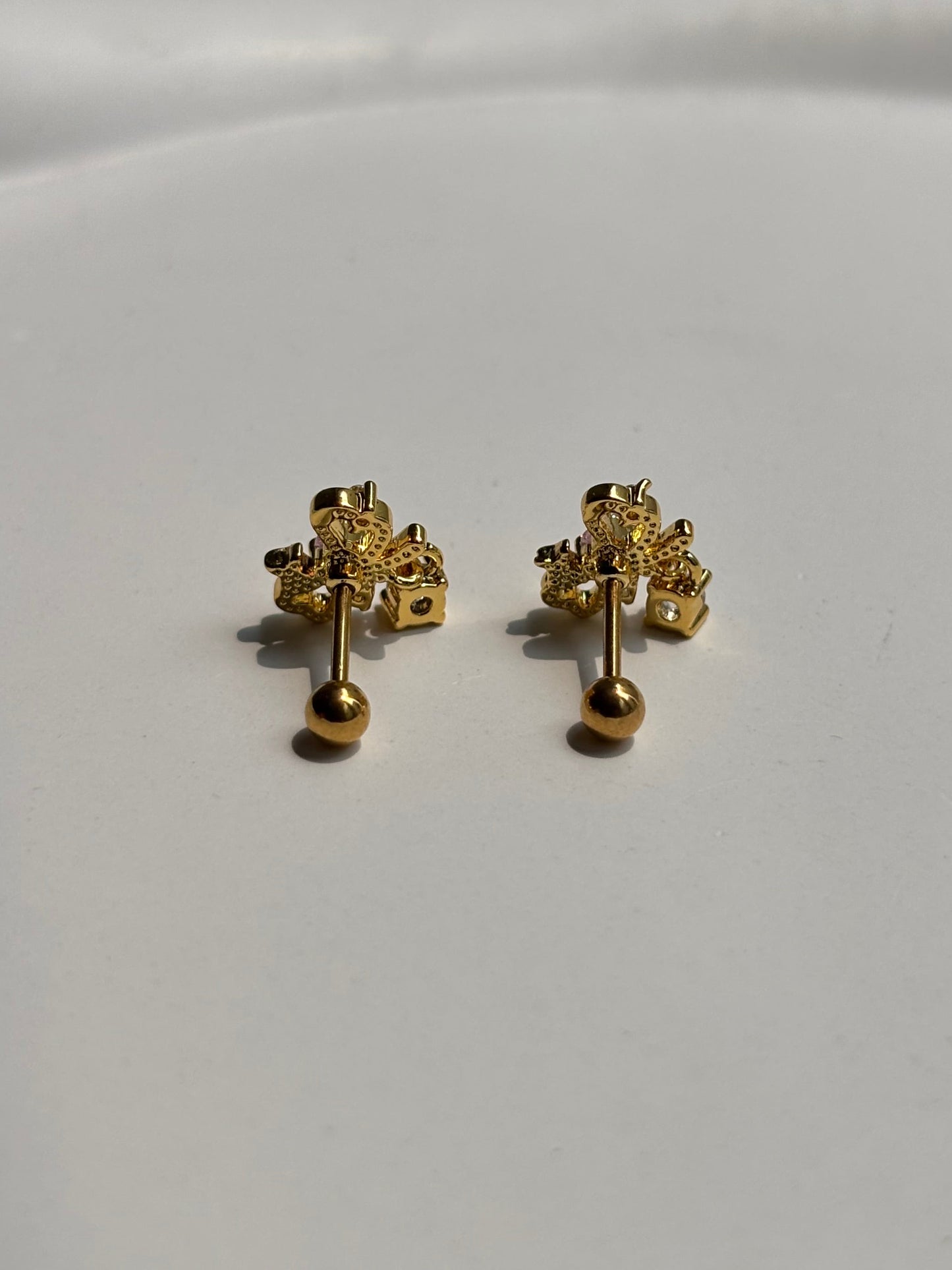 Close-up of 18k gold-plated bow ball-back studs — sleep-friendly, lightweight design for everyday styling.