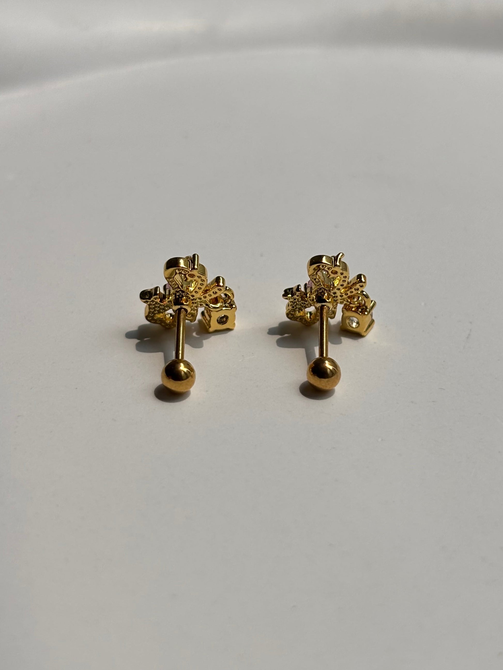 Close-up of 18k gold-plated bow ball-back studs — sleep-friendly, lightweight design for everyday styling.