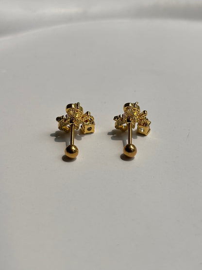 Close-up of 18k gold-plated bow ball-back studs — sleep-friendly, lightweight design for everyday styling.