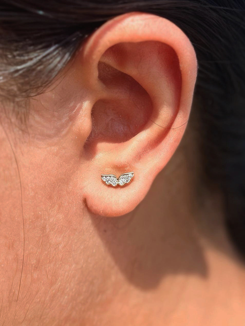 Close-up of wing ball-back stud earrings — 18k gold-plated sleek wing studs for casual wear.