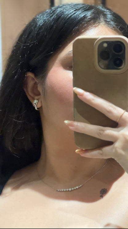 Pair of sterling silver moissanite twist huggies — 925 silver diamond-alternative huggies for everyday-luxury styling.