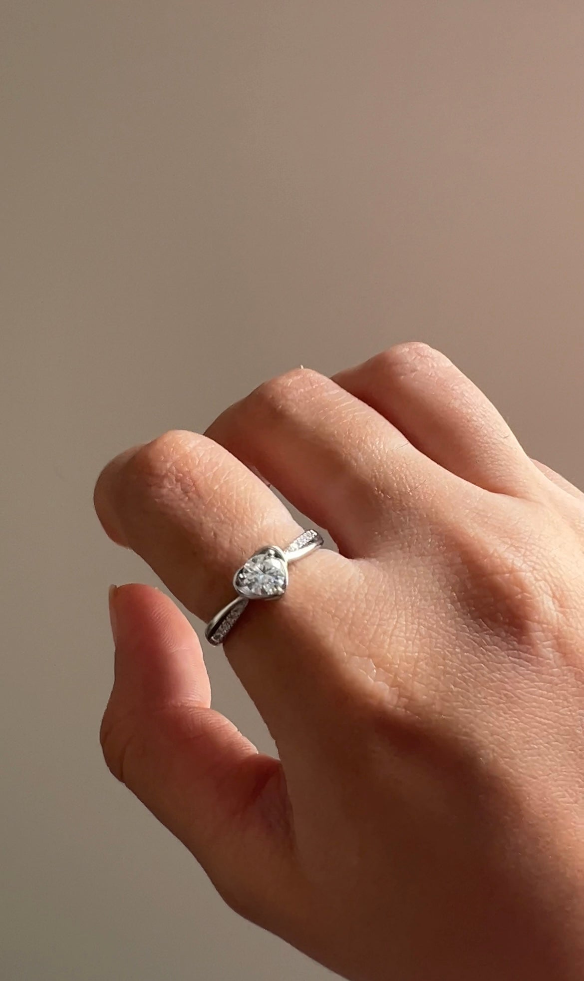 Styled view of Amora heart-cut moissanite ring — sterling silver bridal ring for evening and gifting.