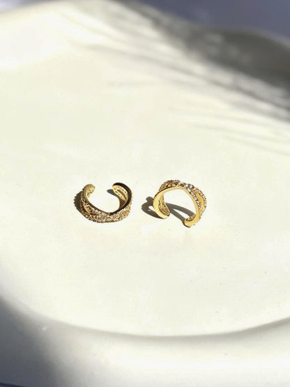 Close-up of gold-plated interlock ear cuff — sleek lightweight cuff for everyday and festive ear stacks.