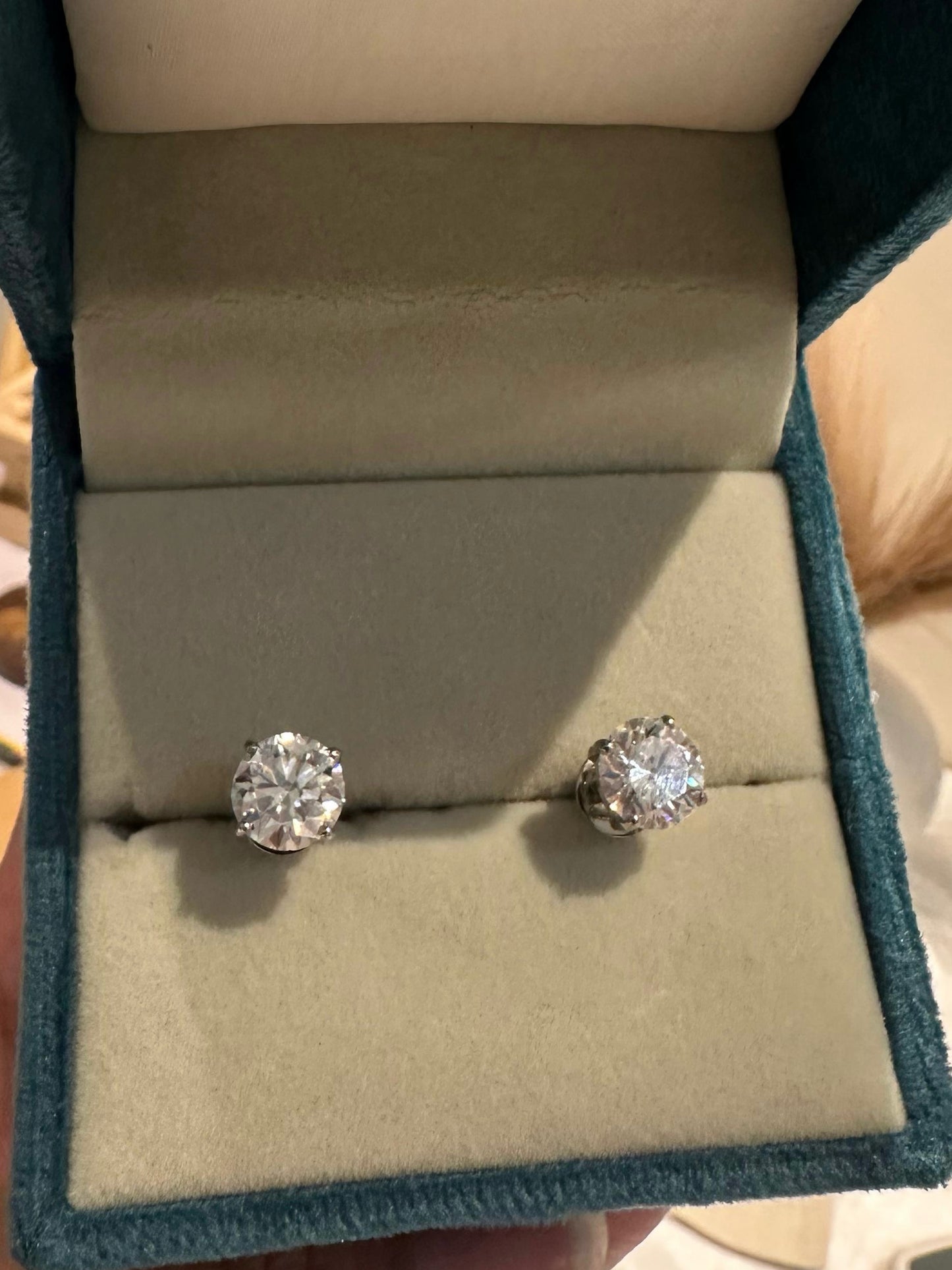 Pair of sterling silver solitaire moissanite studs — elegant diamond-alternative studs for bridal and evening wear.