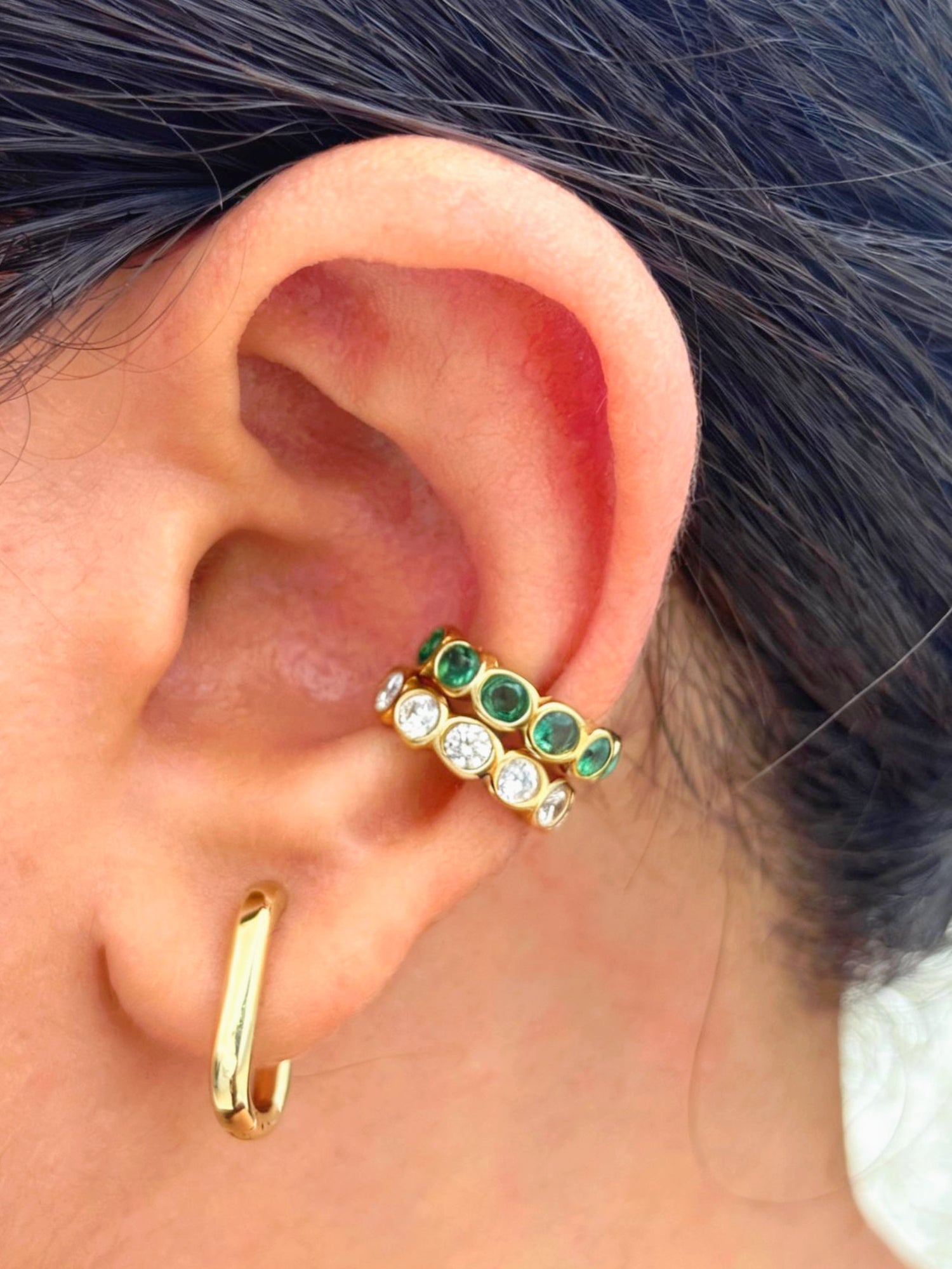 Close-up of gold-plated white stone ear cuff — sleek lightweight cuff for everyday and evening ear stacks.