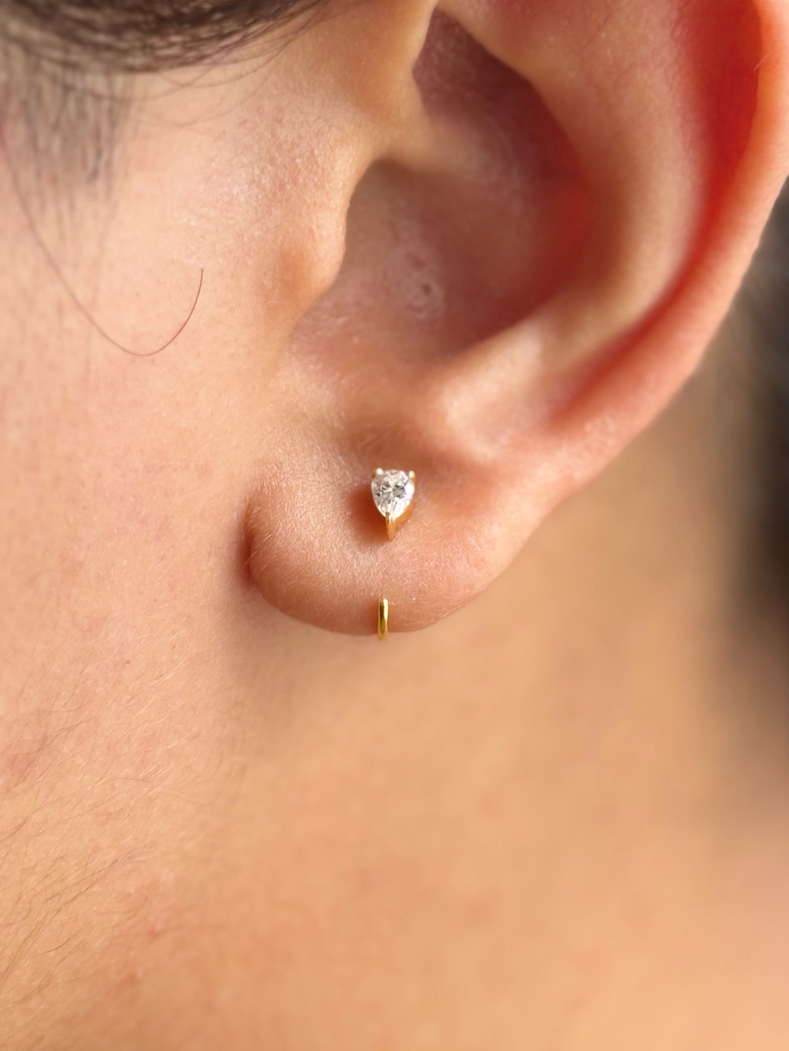 Pair of sterling silver pear hoop earrings in gold finish — minimalist pear hoops for everyday and casual wear.