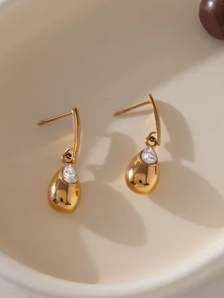 Close-up of 18k gold-plated gold drop earrings — elegant statement drops for ethnic and evening outfits.